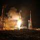 A Soyuz-2.1B rocket booster with a Fregat upper stage lifts off from the Baikonur Cosmodrome to deliver into orbit 36 British OneWeb satellites.